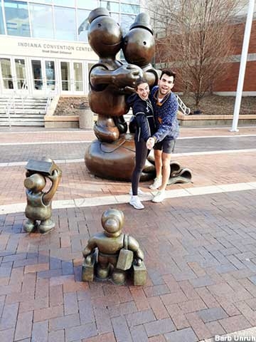 Whimsical Sculpture with Cartoon-Like Figures and Money Bag Motif.