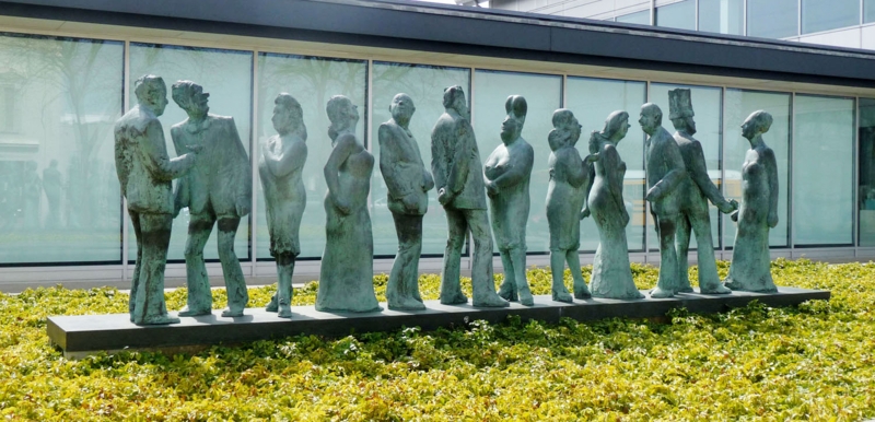 Whimsical Sculpture with Stylized Human Figures and Multi-Tiered Seating.