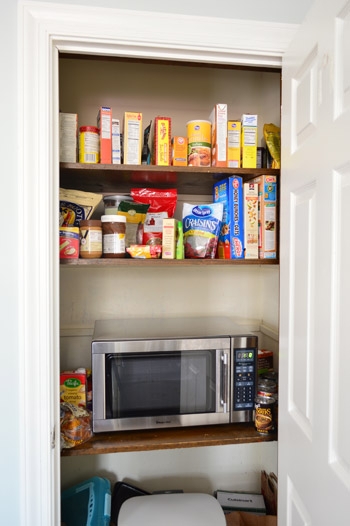 White Walk-In Pantry with Open Shelving & Integrated Microwave
