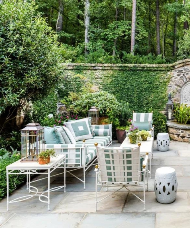 Wood Toned Chaise Lounge Set with White Cushions in Manicured Garden