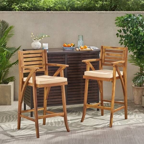 Wood Toned Outdoor Barstools with Vertical Slat Back and Cream Cushions