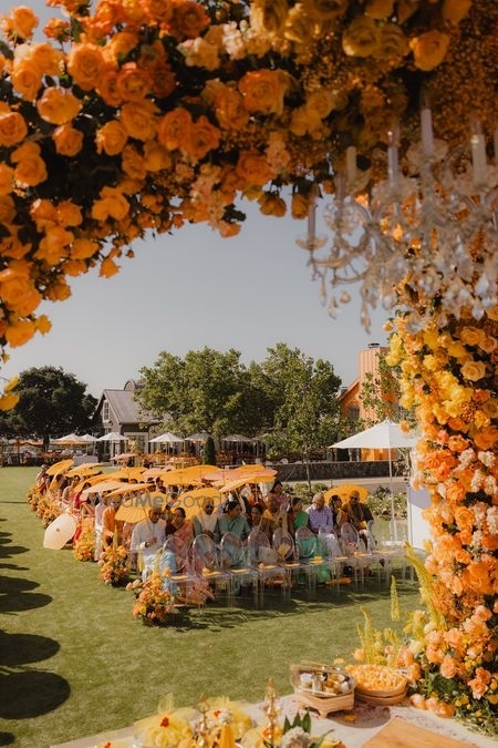 Wooden Mandap featuring Blue Patterned Parasols and Floral Garlands