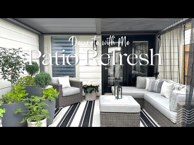 Woven Base Outdoor Sofa with Sage Green Accents & Geometric Rug