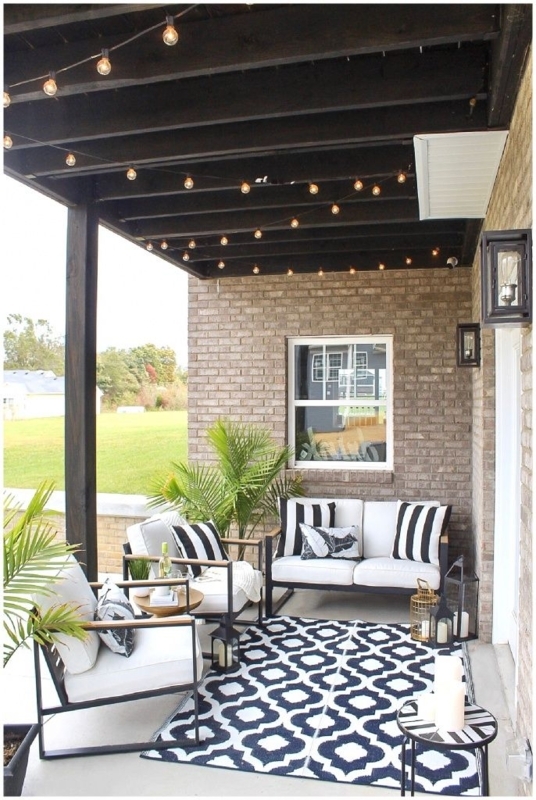Woven Patio Conversation Set Against a Stacked Stone Wall