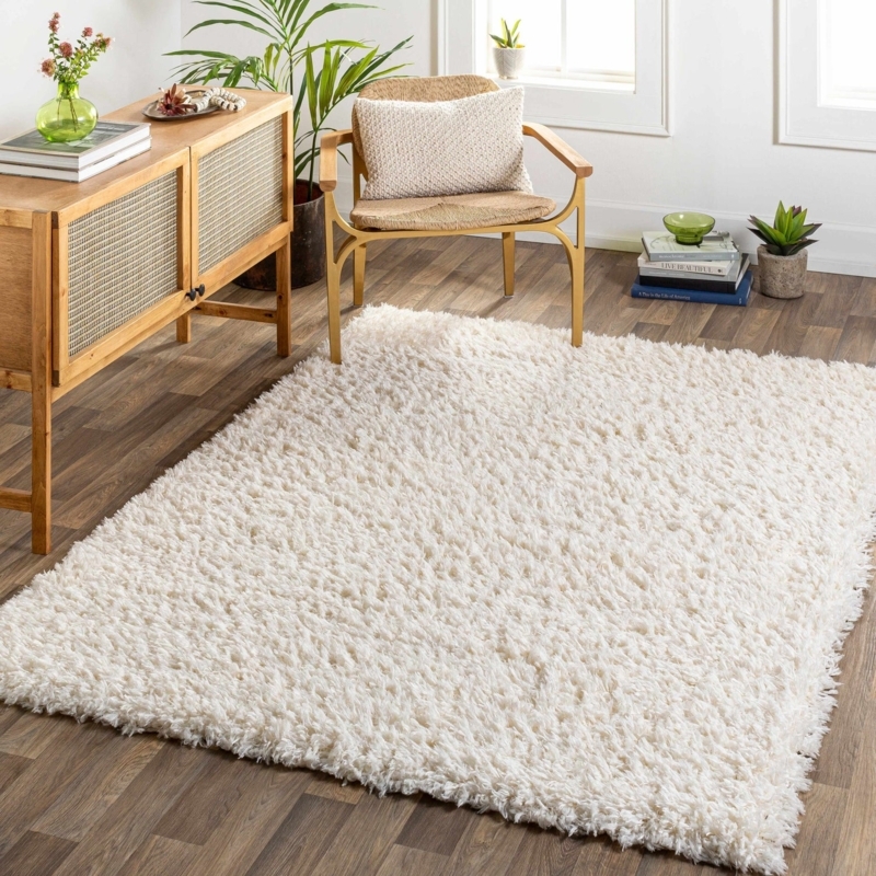 Area Rug: Cozy Cream Shag Placed Against Slatted Wall Backdrop