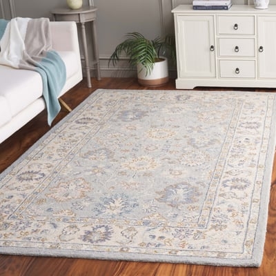 Area Rug with Geometric Lattice Pattern in Light Blue and Cream.