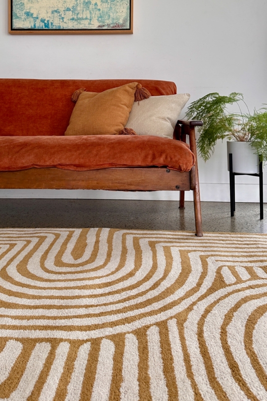 Area Rug with Organic Wavy Pattern in Ochre and Dark Brown Tones.