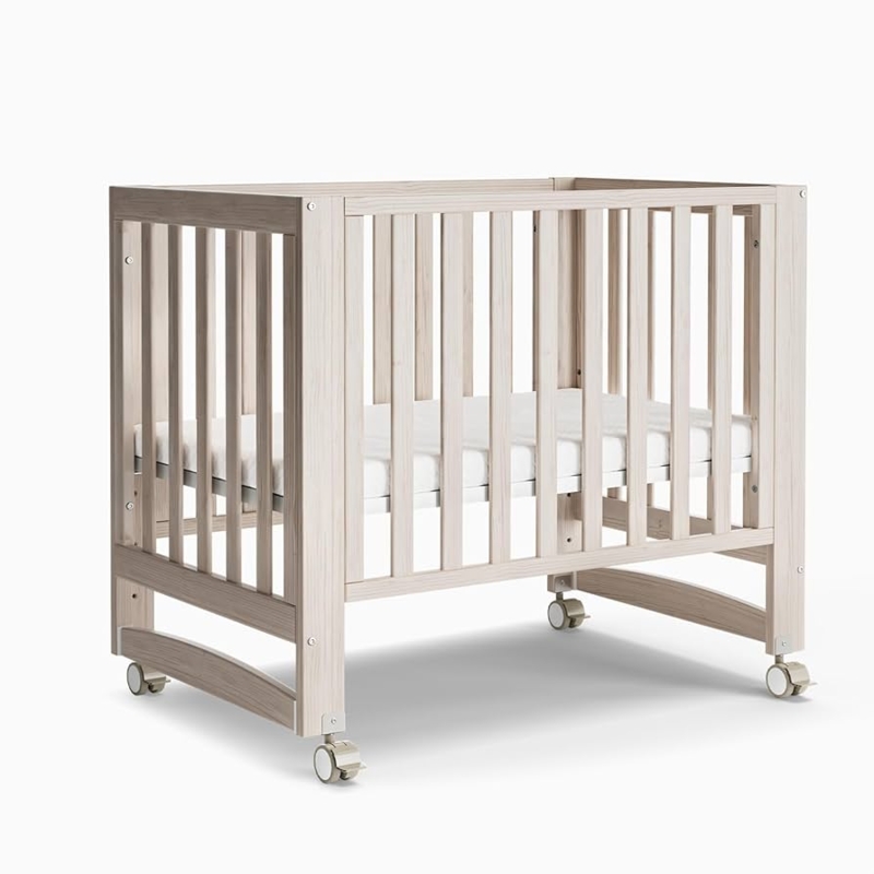 Portable Mini Crib with Locking Casters in Washed Natural Finish