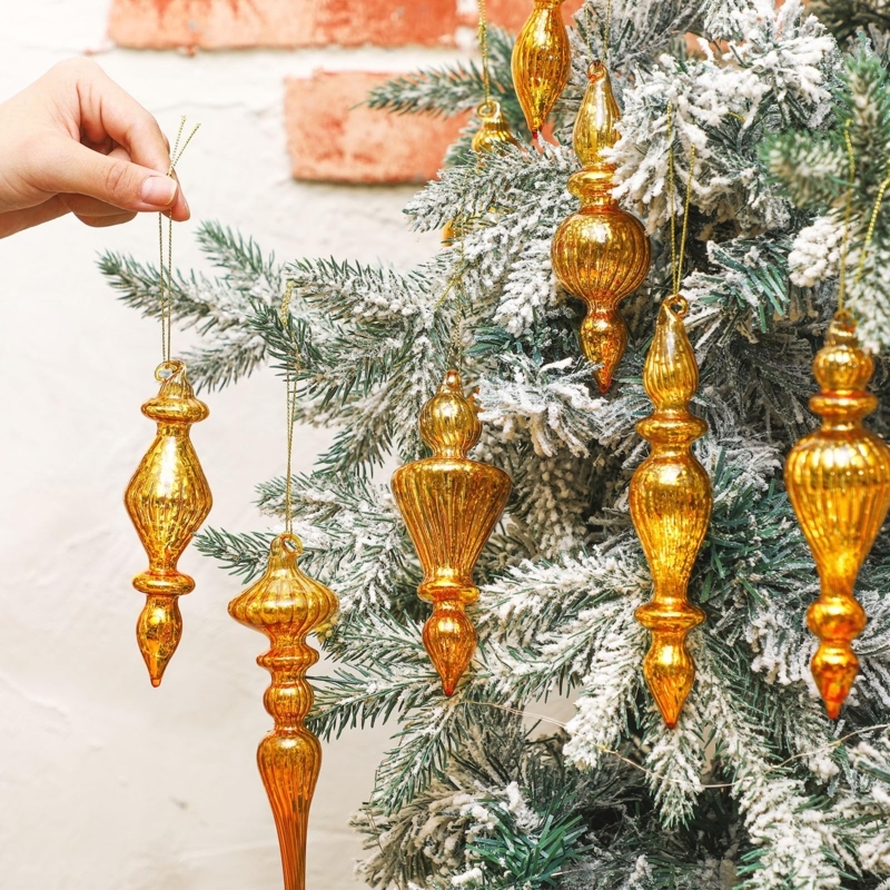 Vintage Mercury Glass Finial Ornaments Against Warm Bokeh Lights