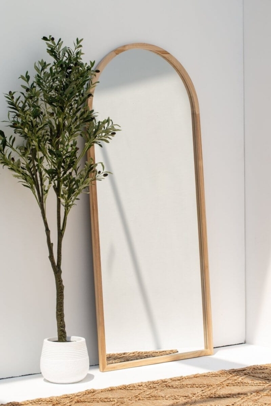 Arched Floor Mirror featuring Thin Light Wood Frame and Leaning Design