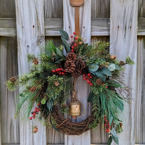 Festive Holiday Wreath with Brass Bells and Red Berry Clusters