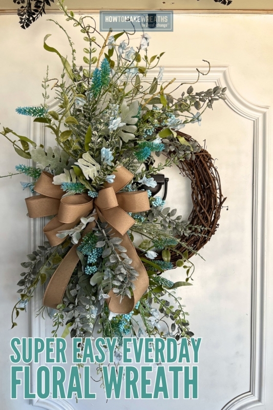 Floral Wreath featuring Vibrant Orange Blooms and Dense Mixed Foliage