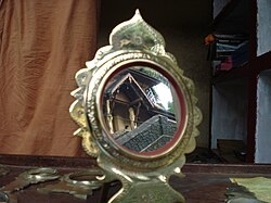 Handheld Mirror Traditional Sculpted Handle, Polished Metal Reflection.