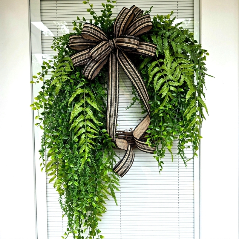 Lush Fern Wreath with Vibrant Green Fronds on Dark Door