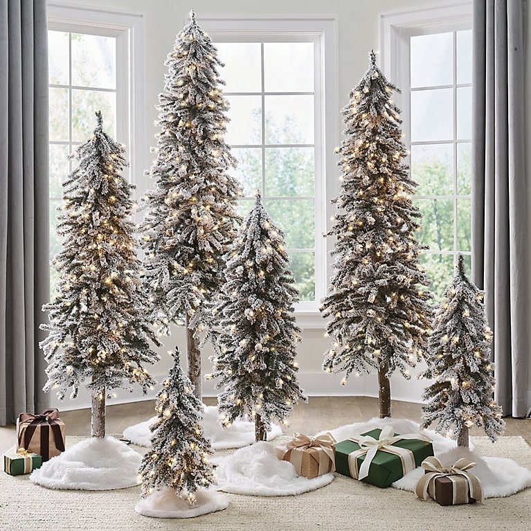 Pre-Lit Flocked Alpine Tree: Sparse Silhouette for Scandinavian Decor.