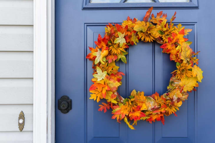 Vibrant Autumn Wreath with Pumpkin Accents on Teal Door
