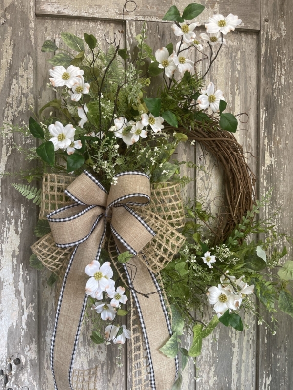 Wreath Featuring Dogwood Blooms and Multi Loop Bow on Grapevine Base