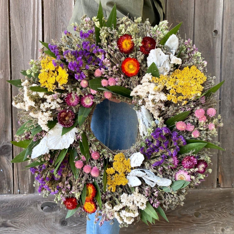 Wreath Featuring Vibrant Multi-Colored Dried Flowers and Broad Foliage