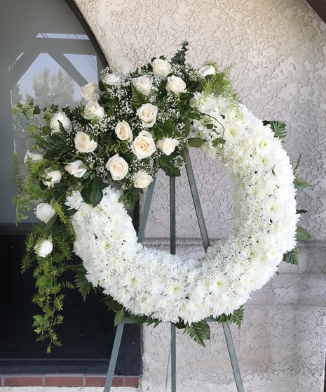 Wreath: Formal Circular Form with Dense Floral Arrangement