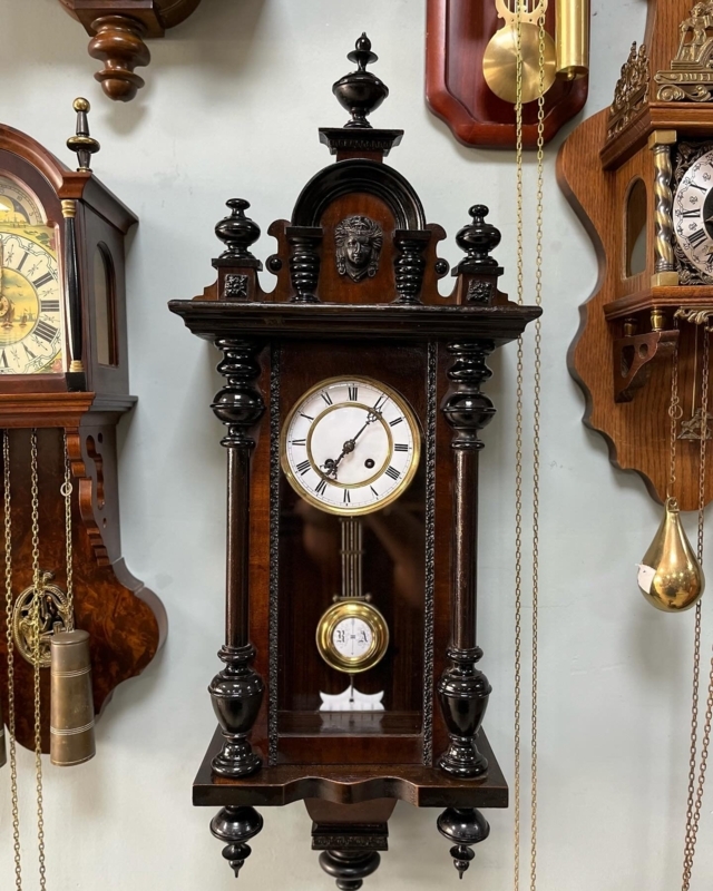 Antique Wall Clock with Ornate Carving and Pendulum Movement