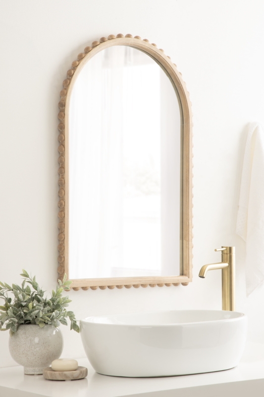 Arched Mirror transitional style features intricate beaded detailing.
