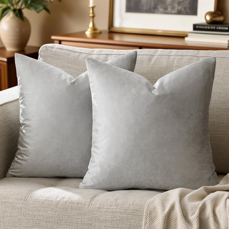 Decorative Throw Pillows in silver grey velvet styled on navy blue sofa