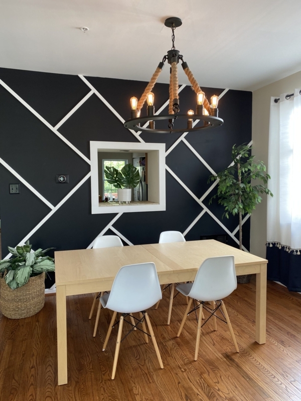 Dining Room featuring Black Accent Wall above White Wainscoting