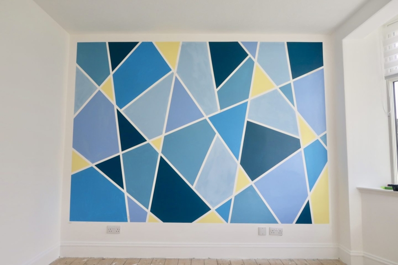 Geometric Accent Wall: Painted Navy Blue Triangle Motif Design