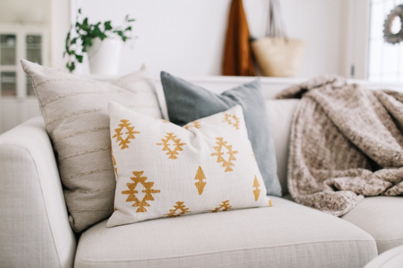 Sectional Sofa Neutral Pillow Styling against Modern Vertical Shiplap