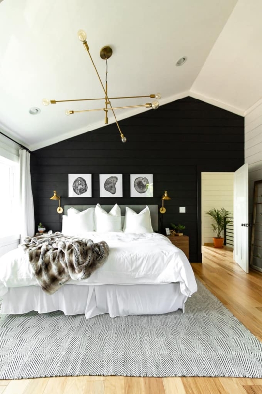 Tall Tufted Wingback Bed against Black Vertical Slat Accent Wall