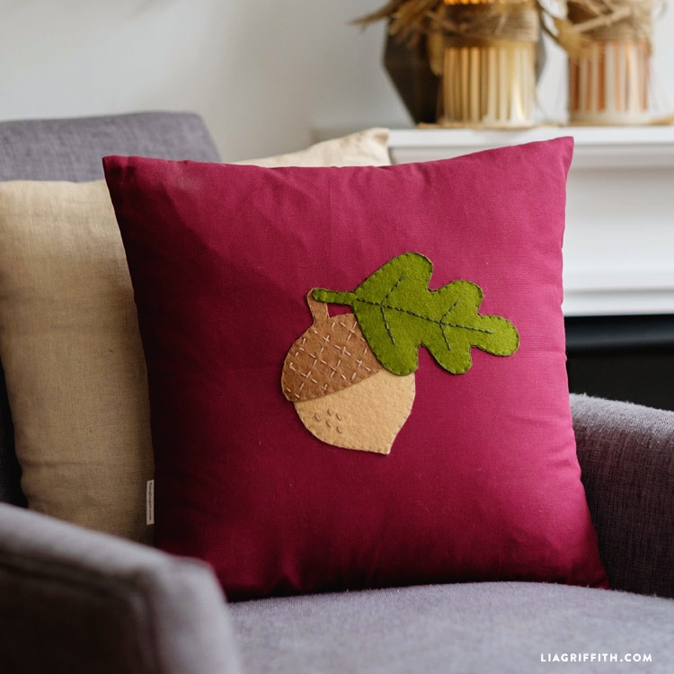 Throw Pillow featuring Rustic Felt Acorn Motif Applique on Cream