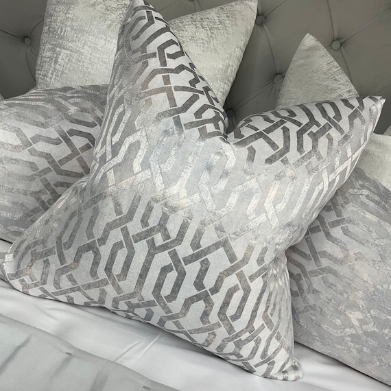 Throw Pillow featuring sharp silver metallic geometric line patterns