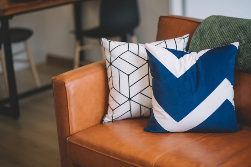 Throw Pillow Mix with Botanical Print and Jewel Tones on Sofa