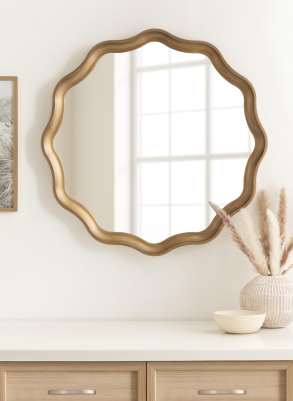 Wall Mirror round silhouette with distinctive wavy frame in gold.