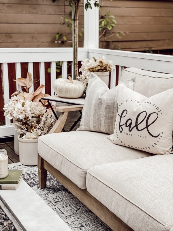 Wooden Outdoor Sectional with Geometric Pattern Rug and Rust Accents