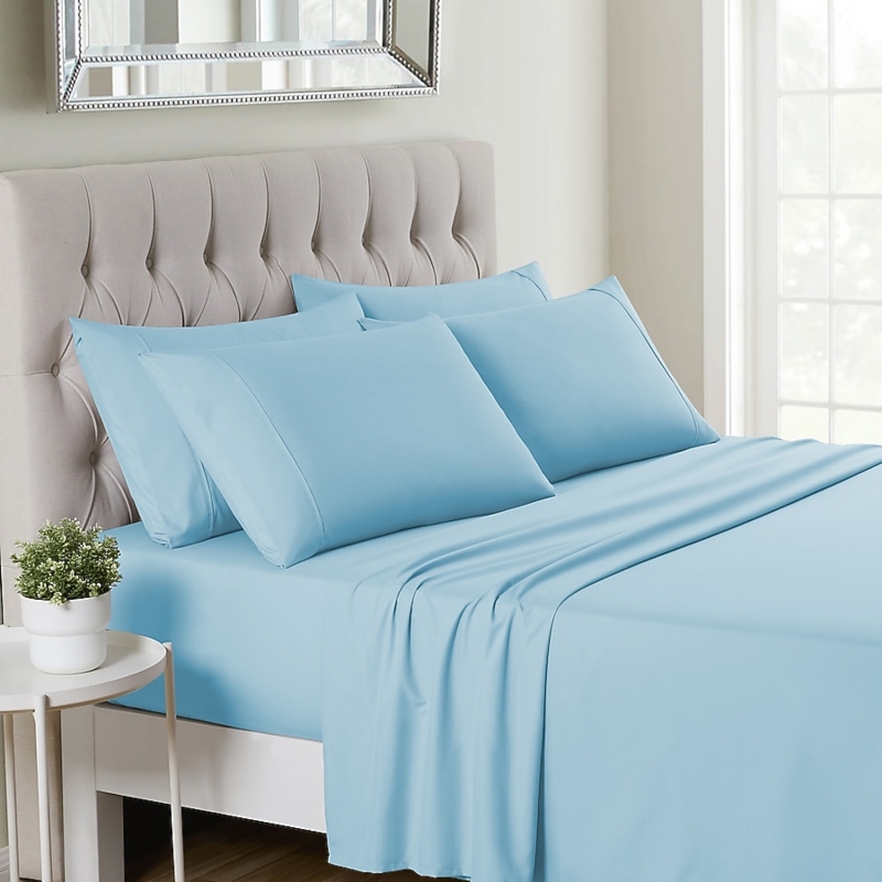 Bed Sheet Set: Light Gray Hue Styled against Tufted Backdrop.