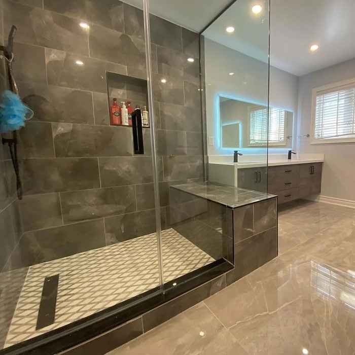 Built-In Shower Bench with Textured Wall Tile and Gold Hardware Accent