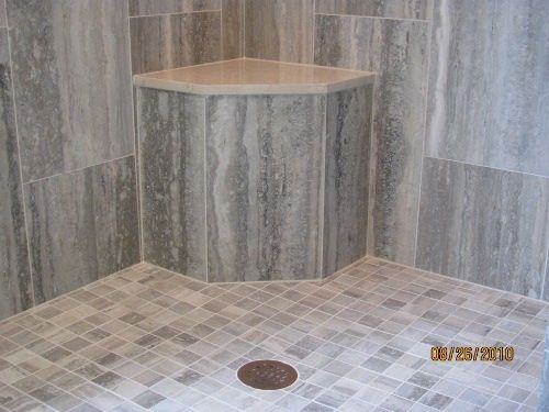 Built In Shower Seat with Large Format Tiles and Pebbled Floor