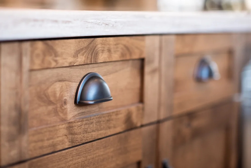 Cabinet Hardware: Brass Hardware on Navy Cabinets with Cup Pulls.