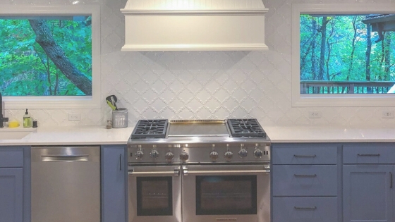 Cabinet Hardware: Brushed Gold Pulls on Matte Navy Shaker Cabinets.