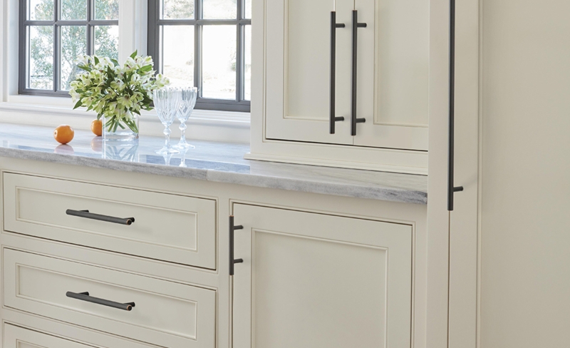 Cabinet Hardware: Gold Cup Pulls and Knobs on Light Teal Cabinetry