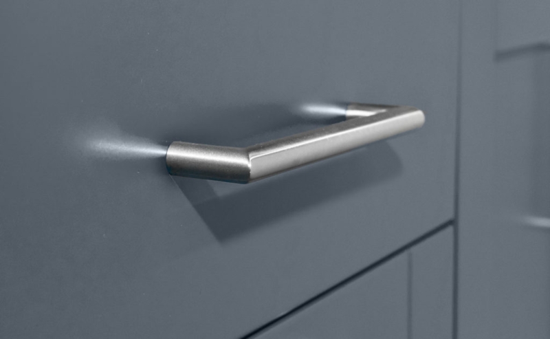 Cabinet Pulls: Brushed Metal Bar Handles on Dark Textured Wood Cabinetry