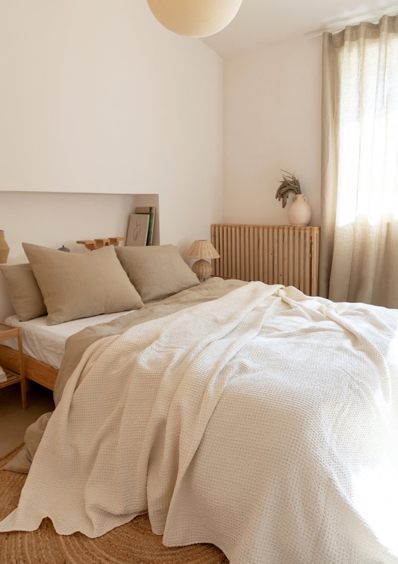 Cream Linen Pillowcases Layered with Textured Waffle Weave Blanket