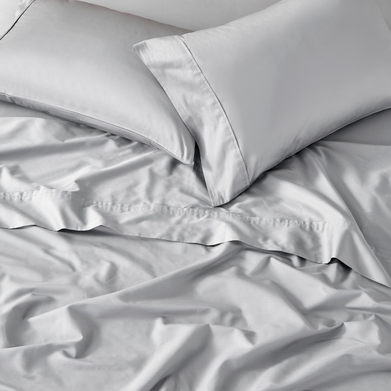 Cream Sateen Sheet Set Neatly Folded for Luxury Bedding Layout