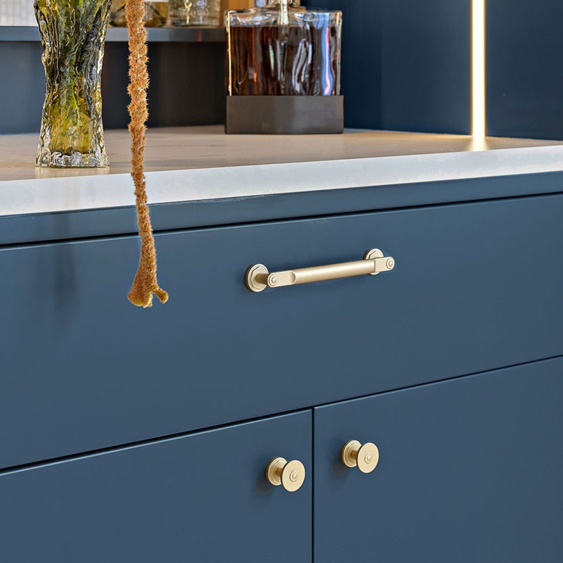 Cylindrical Cabinet Pull: Antique Bronze Finish, Vertical Mount on Grey.