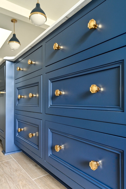 Inset Cabinet Drawers: Dovetail Joinery and Round Brass Hardware Knobs.