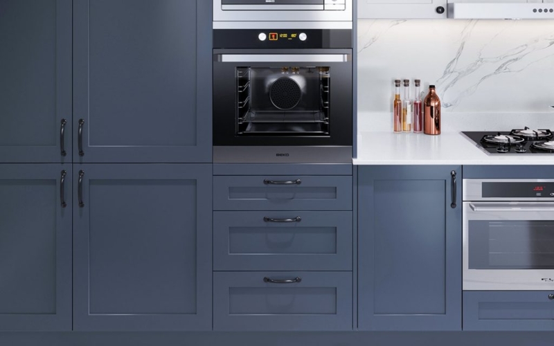 Modern Kitchen Scene: Navy Cabinets, White Herringbone Tile Backsplash.