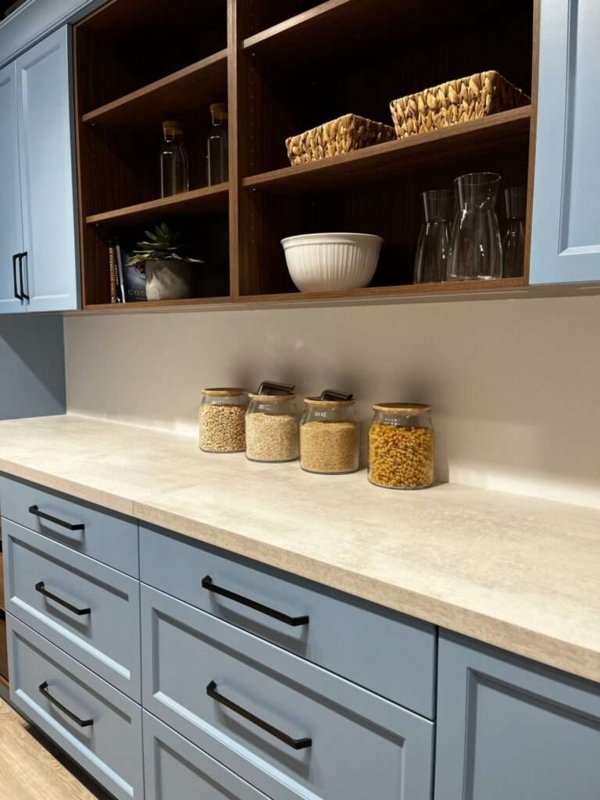Navy Blue Kitchen Island: Brushed Gold Hardware and Black Pendant Lighting.