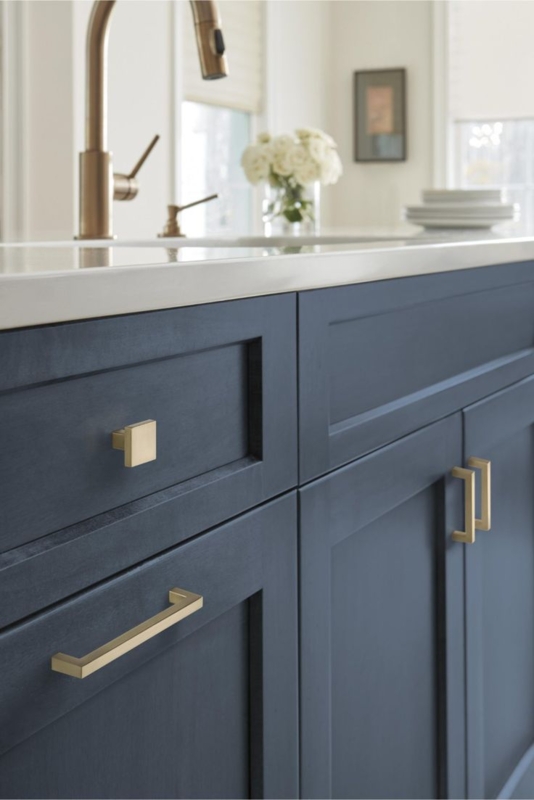 Shaker Cabinetry: Navy Blue with Gold Bridge Faucet and Apron Front Sink.