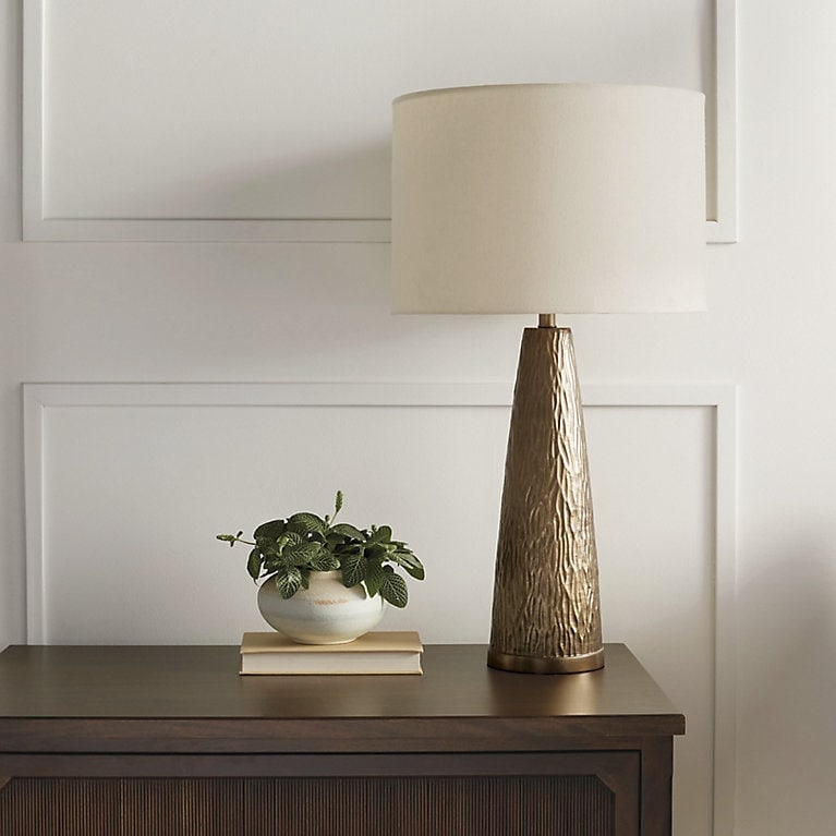 Slender Table Lamp with Hammered Brass Finish Base and Linen Drum Shade.